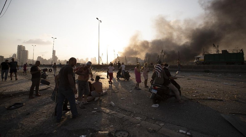 Fire burns after a massive explosion in Beirut, Lebanon, Tuesday, Aug. 4, 2020. Massive explosions rocked downtown Beirut on Tuesday, flattening much of the port, damaging buildings and blowing out windows and doors as a giant mushroom cloud rose above the capital. Witnesses saw many people injured by flying glass and debris. (AP Photo/Hassan Ammar)