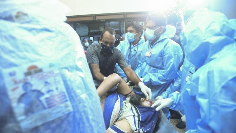 The Air India Express flight that skidded off a runway while landing at the airport in Kozhikode, Kerala state, India, Saturday, Aug. 8, 2020. The special evacuation flight bringing people home to India who had been trapped abroad because of the coronavirus skidded off the runway and split in two while landing in heavy rain killing more than a dozen people and injuring dozens more. (AP Photo/C.K.Thanseer)