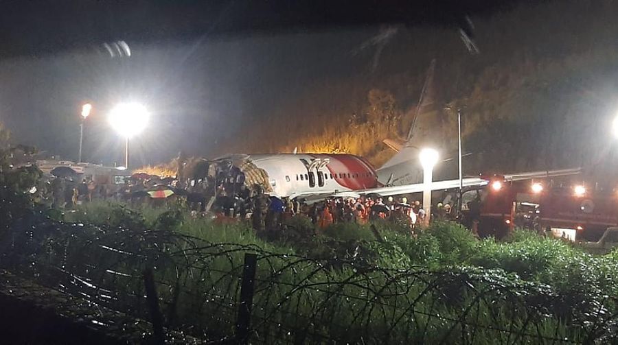 The Air India Express flight that skidded off a runway while landing at the airport in Kozhikode, Kerala state, India, Saturday, Aug. 8, 2020. The special evacuation flight bringing people home to India who had been trapped abroad because of the coronavirus skidded off the runway and split in two while landing in heavy rain killing more than a dozen people and injuring dozens more. (AP Photo/C.K.Thanseer)