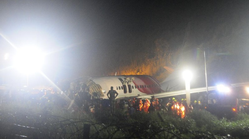 The Air India Express flight that skidded off a runway while landing at the airport in Kozhikode, Kerala state, India, Saturday, Aug. 8, 2020. The special evacuation flight bringing people home to India who had been trapped abroad because of the coronavirus skidded off the runway and split in two while landing in heavy rain killing more than a dozen people and injuring dozens more. (AP Photo/C.K.Thanseer)