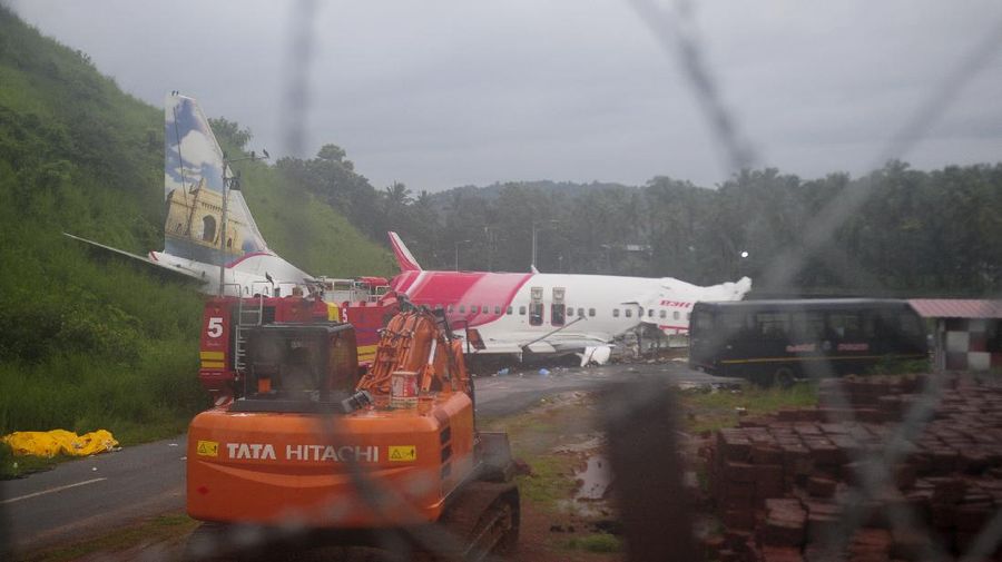 The Air India Express flight that skidded off a runway while landing at the airport in Kozhikode, Kerala state, India, Saturday, Aug. 8, 2020. The special evacuation flight bringing people home to India who had been trapped abroad because of the coronavirus skidded off the runway and split in two while landing in heavy rain killing more than a dozen people and injuring dozens more. (AP Photo/C.K.Thanseer)