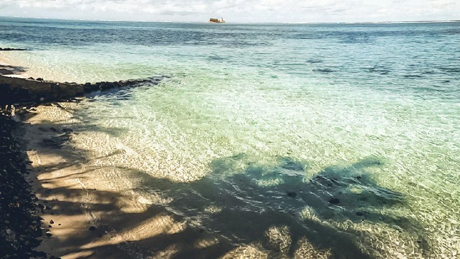 This photo taken and provided by Eric Villars shows oil leaking from the MV Wakashio, a bulk carrier ship that recently ran aground off the southeast coast of Mauritius, Friday, Aug. 7, 2020. Anxious residents of the Indian Ocean island nation of Mauritius are stuffing fabric sacks with sugar cane leaves to create makeshift oil spill barriers as tons of fuel leak from a grounded ship. The government has declared an environmental emergency and France says it is sending help from its nearby Reunion island. (Eric Villars via AP)
