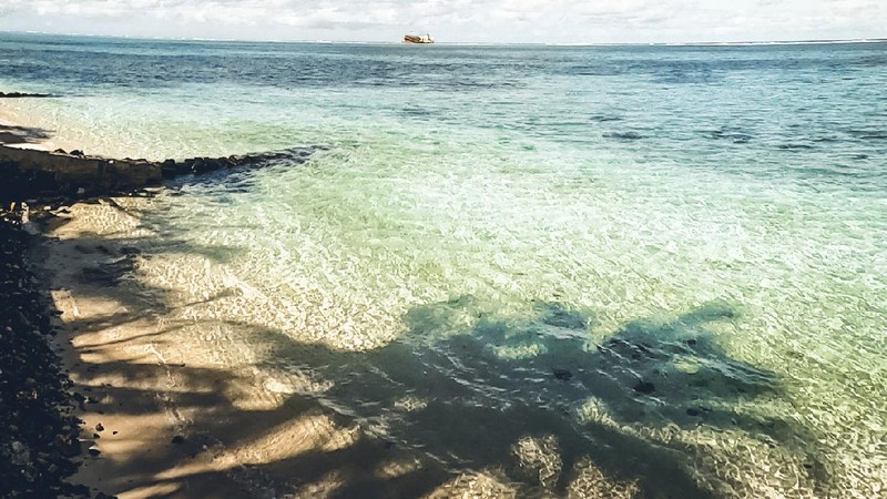 This photo taken and provided by Eric Villars shows oil leaking from the MV Wakashio, a bulk carrier ship that recently ran aground off the southeast coast of Mauritius, Friday, Aug. 7, 2020. Anxious residents of the Indian Ocean island nation of Mauritius are stuffing fabric sacks with sugar cane leaves to create makeshift oil spill barriers as tons of fuel leak from a grounded ship. The government has declared an environmental emergency and France says it is sending help from its nearby Reunion island. (Eric Villars via AP)