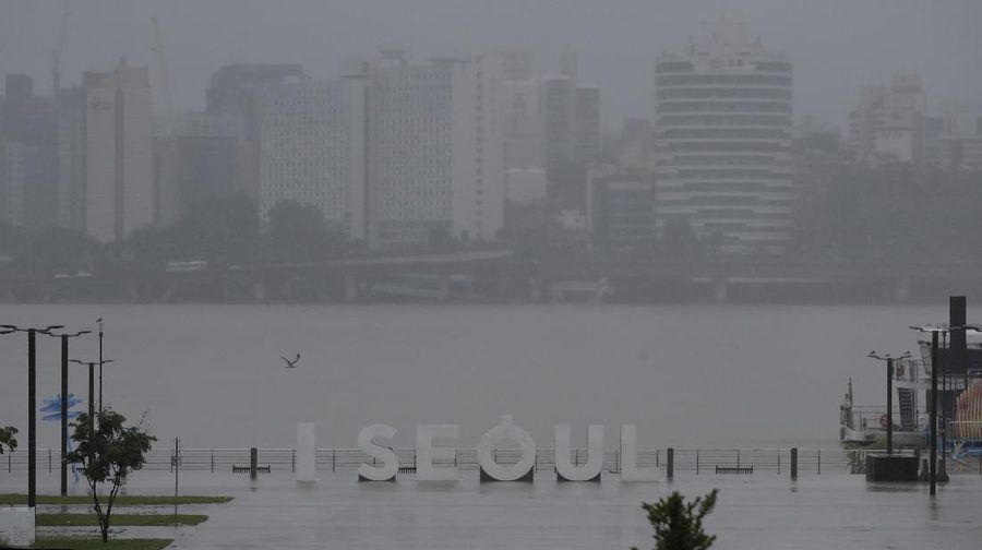 A herd of cattle are seen on the roof of houses after the water drained from the submerged residential area, following heavy rain in Gurye, South Korea, Sunday, Aug. 9, 2020. More than a week of torrential rain in South Korea has caused deadly landslides, floods and other incidents while the government is warning of further downpour. (Park Chul-heung/Yonhap via AP)