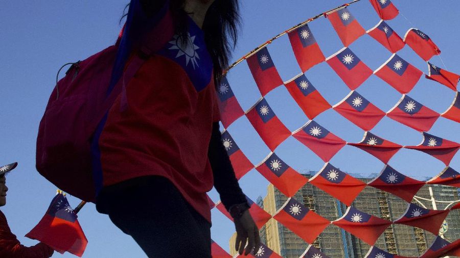Supporters of Han Kuo-yu, Taiwan's 2020 presidential election candidate for the KMT or Nationalist Party, cheer with their national flag during a campaign rally in Taipei, Taiwan, Thursday, Jan. 9, 2020. Taiwan will hold its presidential election on Jan. 11. (AP Photo/Ng Han Guan)