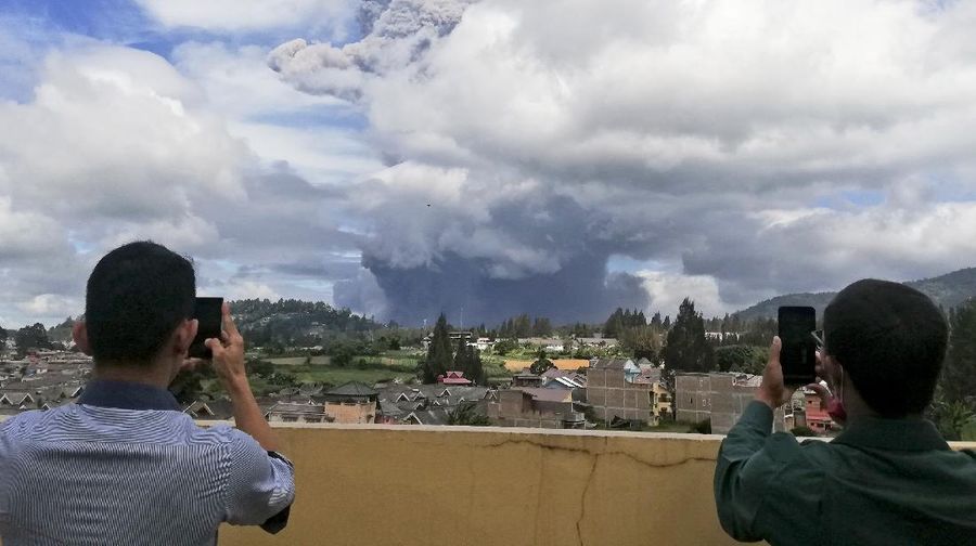 Mount Sinabung spews volcanic materials into the air as it erupts, in Karo, North Sumatra, Indonesia, Monday, Aug. 10, 2020. The rumbling volcano erupted Monday, sending a column of volcanic materials a few thousands meters into the sky. Sinabung is among more than 120 active volcanoes in Indonesia, which is prone to seismic upheaval due to its location on the Pacific