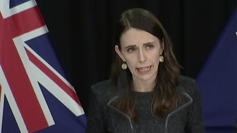 A news alert is displayed on a mobile phone in Christchurch, New Zealand, Tuesday, Aug. 11, 2020. New Zealand Prime Minister Jacinda Ardern said Tuesday that authorities have found four cases of the coronavirus in one Auckland household from an unknown source, the first cases of local transmission in the country in 102 days. (AP Photo/Mark Baker)