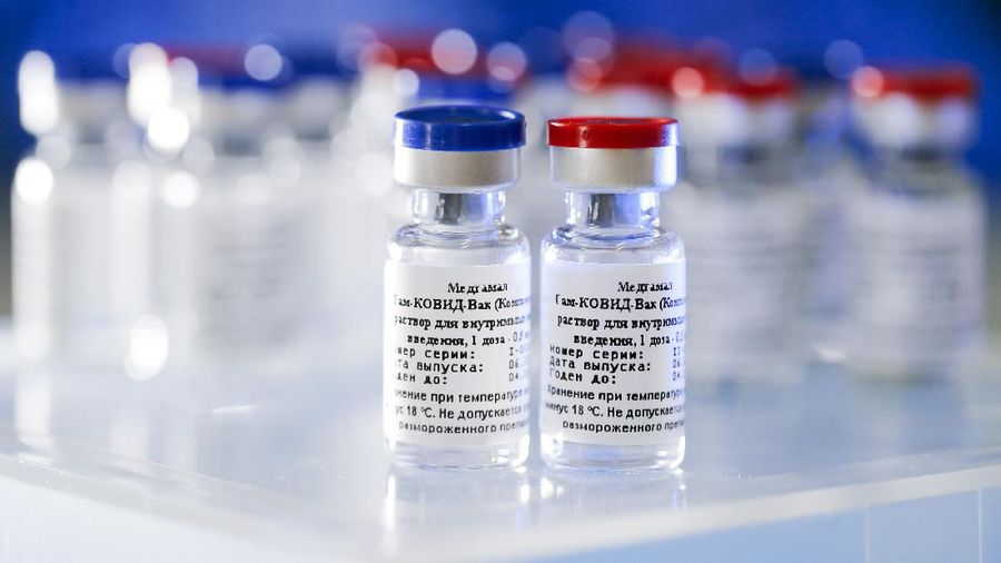 In this handout photo taken on Thursday, Aug. 6, 2020, and provided by Russian Direct Investment Fund, an employee shows a new vaccine at the Nikolai Gamaleya National Center of Epidemiology and Microbiology in Moscow, Russia. Russia on Tuesday, Aug. 11 became the first country to approve a coronavirus vaccine for use in tens of thousands of its citizens despite international skepticism about injections that have not completed clinical trials and were studied in only dozens of people for less than two months. (Alexander Zemlianichenko Jr/ Russian Direct Investment Fund via AP)