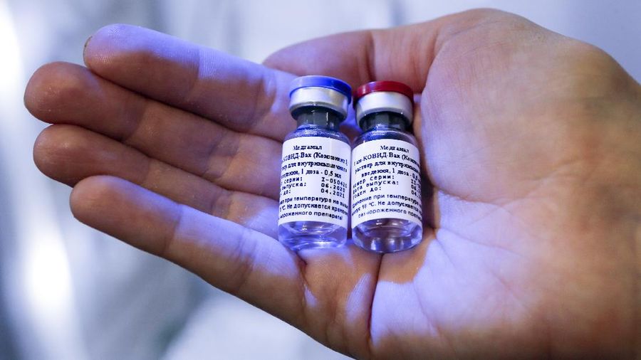 In this handout photo taken on Thursday, Aug. 6, 2020, and provided by Russian Direct Investment Fund, an employee shows a new vaccine at the Nikolai Gamaleya National Center of Epidemiology and Microbiology in Moscow, Russia. Russia on Tuesday, Aug. 11 became the first country to approve a coronavirus vaccine for use in tens of thousands of its citizens despite international skepticism about injections that have not completed clinical trials and were studied in only dozens of people for less than two months. (Alexander Zemlianichenko Jr/ Russian Direct Investment Fund via AP)
