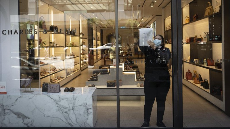 A retail shop staff prepare to reopen in Kuala Lumpur, Malaysia, on Monday, May 4, 2020. Many business sectors reopened Monday in some parts of Malaysia since a partial virus lockdown began March 18. The easing of restrictions, days before the lockdown was due to end May 12, came as Prime Minister Muhyiddin Yassin's government sought to balance between curbing the virus and reviving the hard-hit economy.(AP Photo/Vincent Thian)