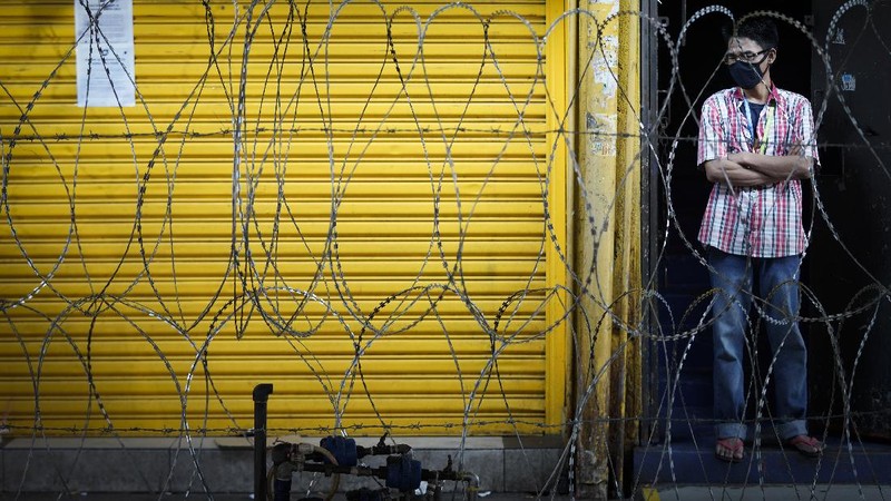 A retail shop staff prepare to reopen in Kuala Lumpur, Malaysia, on Monday, May 4, 2020. Many business sectors reopened Monday in some parts of Malaysia since a partial virus lockdown began March 18. The easing of restrictions, days before the lockdown was due to end May 12, came as Prime Minister Muhyiddin Yassin's government sought to balance between curbing the virus and reviving the hard-hit economy.(AP Photo/Vincent Thian)