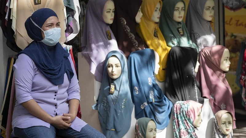 A retail shop staff prepare to reopen in Kuala Lumpur, Malaysia, on Monday, May 4, 2020. Many business sectors reopened Monday in some parts of Malaysia since a partial virus lockdown began March 18. The easing of restrictions, days before the lockdown was due to end May 12, came as Prime Minister Muhyiddin Yassin's government sought to balance between curbing the virus and reviving the hard-hit economy.(AP Photo/Vincent Thian)