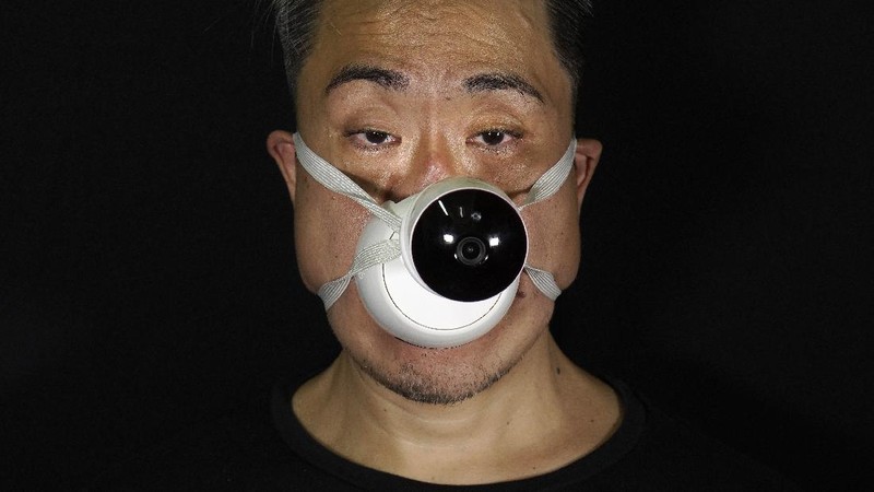 This combination of photos shows Edmond Kok, a Hong Kong theater costume designer and actor, wearing a variety of face masks he made to protect against the coronavirus in Hong Kong Thursday, Aug. 6, 2020. With little theater work because of the coronavirus pandemic, Kok has found a way to turn the now ubiquitous face mask into a creative opportunity. Since February, he has created more than 170 face masks inspired both by the pandemic and Hong Kong’s political problems - not for actual use but as pieces of art. (AP Photo/Vincent Yu)
