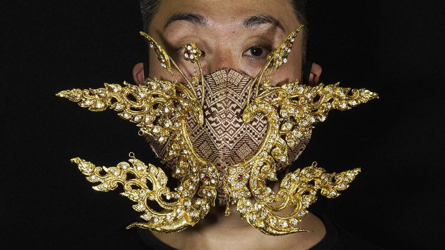 This combination of photos shows Edmond Kok, a Hong Kong theater costume designer and actor, wearing a variety of face masks he made to protect against the coronavirus in Hong Kong Thursday, Aug. 6, 2020. With little theater work because of the coronavirus pandemic, Kok has found a way to turn the now ubiquitous face mask into a creative opportunity. Since February, he has created more than 170 face masks inspired both by the pandemic and Hong Kong’s political problems - not for actual use but as pieces of art. (AP Photo/Vincent Yu)