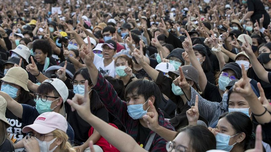 Pro-democracy activities gestures during a protest at Democracy Monument in Bangkok, Thailand, Sunday, Aug, 16, 2020. Protesters have stepped up pressure on the government demanding to dissolve the parliament, hold new elections, amend the constitution and end intimidation of the government's opponents. (AP Photo/Gemunu Amarasinghe)