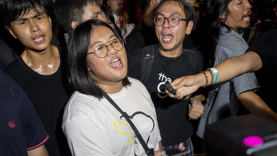 Pro-democracy activities gestures during a protest at Democracy Monument in Bangkok, Thailand, Sunday, Aug, 16, 2020. Protesters have stepped up pressure on the government demanding to dissolve the parliament, hold new elections, amend the constitution and end intimidation of the government's opponents. (AP Photo/Gemunu Amarasinghe)