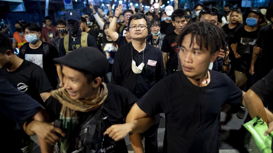 Pro-democracy activities gestures during a protest at Democracy Monument in Bangkok, Thailand, Sunday, Aug, 16, 2020. Protesters have stepped up pressure on the government demanding to dissolve the parliament, hold new elections, amend the constitution and end intimidation of the government's opponents. (AP Photo/Gemunu Amarasinghe)