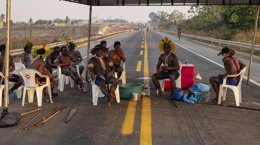 Kayapo men block highway BR-163 in protest, near Novo Progresso, Para state, Brazil, Thursday, Aug. 20, 2020. The protesters blocked the road to pressure Brazilian President Jair Bolsonaro to better protect them from COVID-19, to extend damages payments for road construction near their land, and to consult them on a proposed railway to transport soybeans and corn. (AP Photo/Andre Penner)