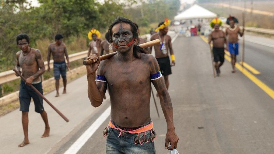 Kayapo men block highway BR-163 in protest, near Novo Progresso, Para state, Brazil, Thursday, Aug. 20, 2020. The protesters blocked the road to pressure Brazilian President Jair Bolsonaro to better protect them from COVID-19, to extend damages payments for road construction near their land, and to consult them on a proposed railway to transport soybeans and corn. (AP Photo/Andre Penner)