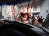 Casts as zombies perform by the window of a vehicle during a demonstration of a drive-in haunted house show at a garage Tuesday, Aug. 18, 2020, in Tokyo. Visitors remain in vehicles as taking prevention measures against the COVID-19 pandemic, while g