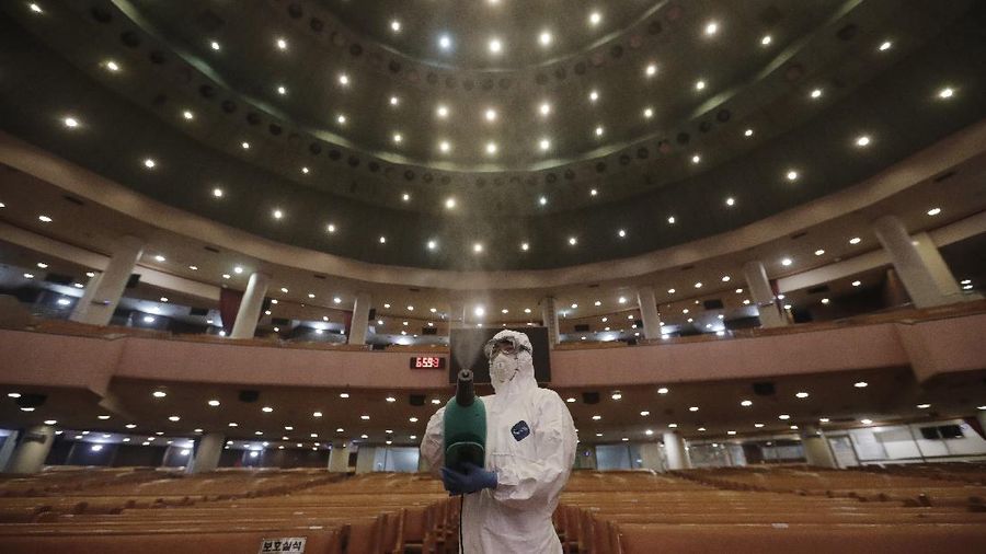A public official disinfects as a precaution against the coronavirus at the Yoido Full Gospel Church in Seoul, South Korea, Friday, Aug. 21, 2020. South Korea's Centers for Disease Control and Prevention on Friday reported new infections from practically all major cities nationwide, including Busan, Gwangju, Daejeon, Sejong and Daegu, a southeastern city that was the epicenter of a massive outbreak in late February and March. (AP Photo/Ahn Young-joon)