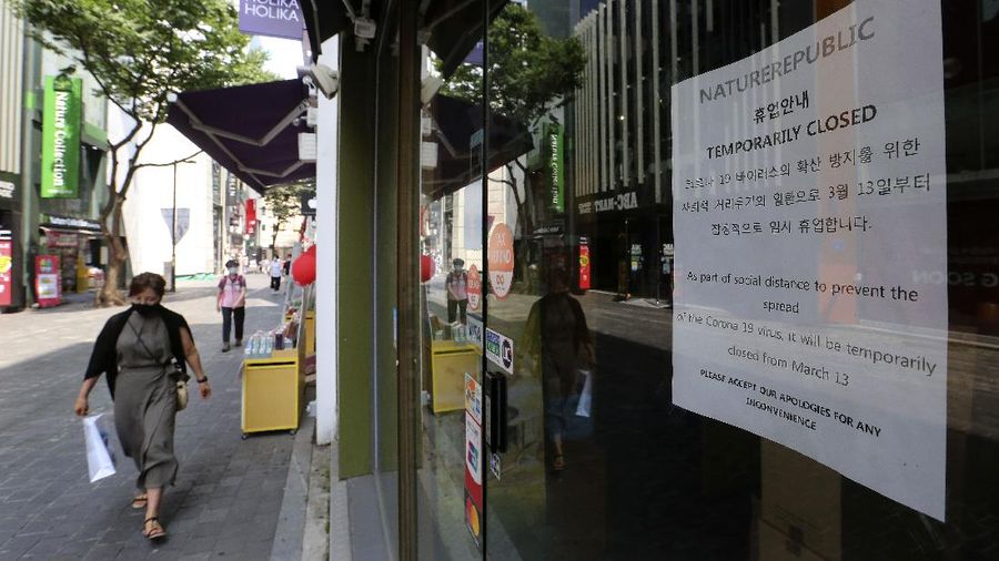 A notice is seen at the entrance of a temporarily closed store at a shopping district in Seoul, South Korea, Sunday, Aug. 23, 2020. South Korea has added nearly 400 new coronavirus cases, counting its tenth straight day of triple-digit increases as the speed of viral spread nears the levels the country saw during the worst of its outbreak in spring. (AP Photo/Ahn Young-joon)