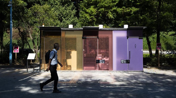 Japan Transparent Toilet A man gets out of one of the transparent glass toilets after use at Yoyogi Hukamachi Mini Park in Tokyo on Thursday, Aug. 20, 2020. The bathrooms with the tinted wall turn opaque when it's in use. The walls of two newly installed public toilets in Tokyo's Shibuya neighborhood are see-through before people enter, but turn opaque when the doors are closed and locked from the inside. The so-called transparent toilets, which opened this month, were designed by award-winning Japanese architect Shigeru Ban for a project organized by The Nippon Foundation that redesigned a total of 17 public toilets in the neighborhood. (AP Photo/Hiro Komae)
