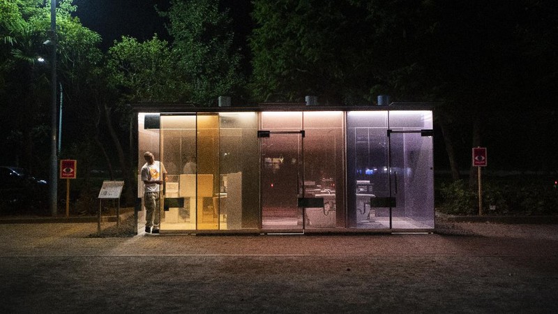 A man gets out of one of the transparent glass toilets after use at Yoyogi Hukamachi Mini Park in Tokyo on Thursday, Aug. 20, 2020. The bathrooms with the tinted wall turn opaque when it's in use. The walls of two newly installed public toilets in Tokyo's Shibuya neighborhood are see-through before people enter, but turn opaque when the doors are closed and locked from the inside. The so-called transparent toilets, which opened this month, were designed by award-winning Japanese architect Shigeru Ban for a project organized by The Nippon Foundation that redesigned a total of 17 public toilets in the neighborhood. (AP Photo/Hiro Komae)