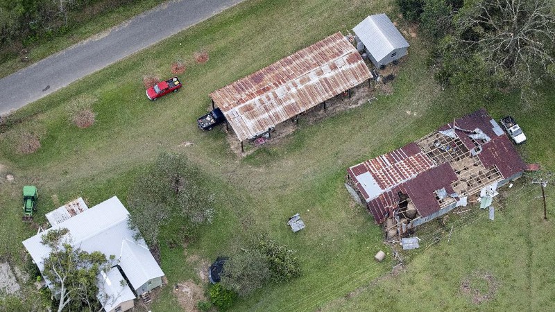 Fallen trees and damaged roofs are left in the aftermath of Hurricane Laura, Friday, Aug. 28, 2020, in DeRidder, La., as seen during Gov. John Bel Edwards' aerial tour of stricken areas in the northern part of the state. (Bill Feig/The Advocate via AP, Pool)