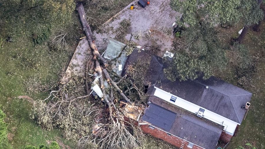 Fallen trees and damaged roofs are left in the aftermath of Hurricane Laura, Friday, Aug. 28, 2020, in DeRidder, La., as seen during Gov. John Bel Edwards' aerial tour of stricken areas in the northern part of the state. (Bill Feig/The Advocate via AP, Pool)