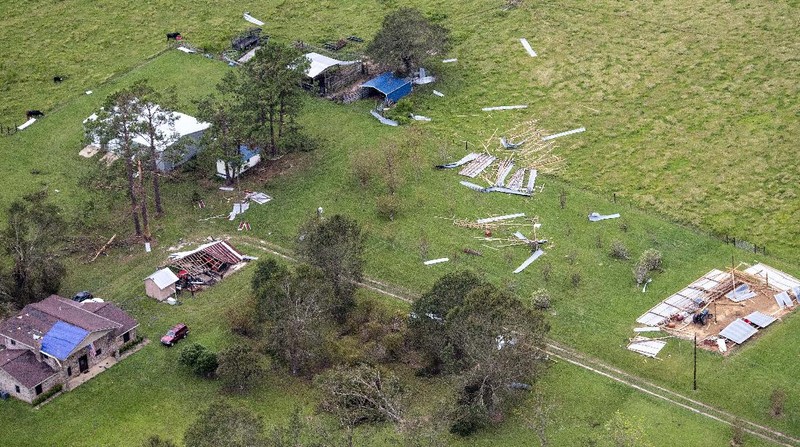 Fallen trees and damaged roofs are left in the aftermath of Hurricane Laura, Friday, Aug. 28, 2020, in DeRidder, La., as seen during Gov. John Bel Edwards' aerial tour of stricken areas in the northern part of the state. (Bill Feig/The Advocate via AP, Pool)
