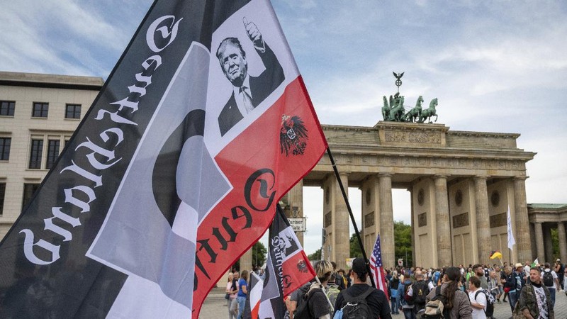People attend a protest rally in Berlin, Germany, Saturday, Aug. 29, 2020 against new coronavirus restrictions in Germany. Police in Berlin have requested thousands of reinforcements from other parts of Germany to cope with planned protests at the weekend by people opposed to coronavirus restrictions. (AP Photo/Michael Sohn)