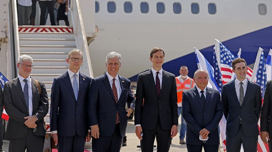U.S. Presidential Adviser Jared Kushner, center right, and U.S. National Security Adviser Robert O'Brien, center left, pose with members of the Israeli-American delegation in front of the El Al's flight, which will carry the delegation from Tel Aviv to Abu Dhabi, at the Ben-Gurion Airport near Tel Aviv, Israel Monday,  Aug. 31, 2020. (Menahem Kahana/Pool Phovo via AP)