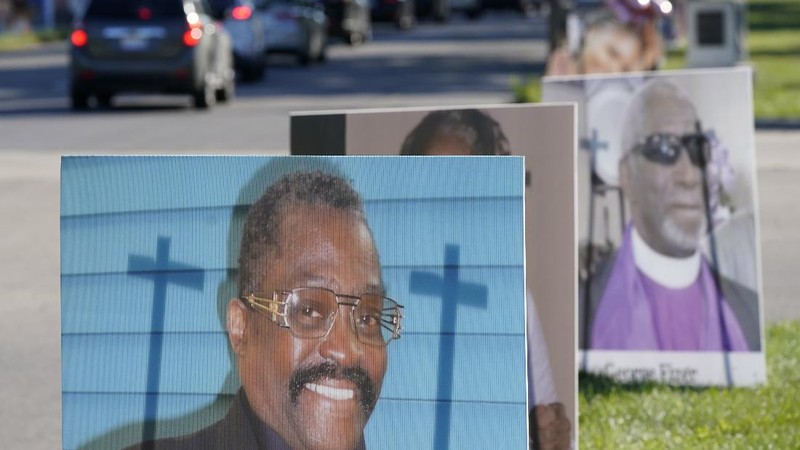 Some of the nearly 900 large poster-sized photos of Detroit victims of COVID-19 are displayed, Monday, Aug. 31, 2020 on Belle Isle in Detroit. Families have a chance to take one last public look at their lost loved ones in the nation's first citywide memorial to honor victims of the pandemic. Mourners will join 14 consecutive funeral processions to drive past the photos of their loved ones staked around the island. (AP Photo/Carlos Osorio)