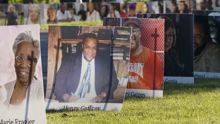 Some of the nearly 900 large poster-sized photos of Detroit victims of COVID-19 are displayed, Monday, Aug. 31, 2020 on Belle Isle in Detroit. Families have a chance to take one last public look at their lost loved ones in the nation's first citywide memorial to honor victims of the pandemic. Mourners will join 14 consecutive funeral processions to drive past the photos of their loved ones staked around the island. (AP Photo/Carlos Osorio)