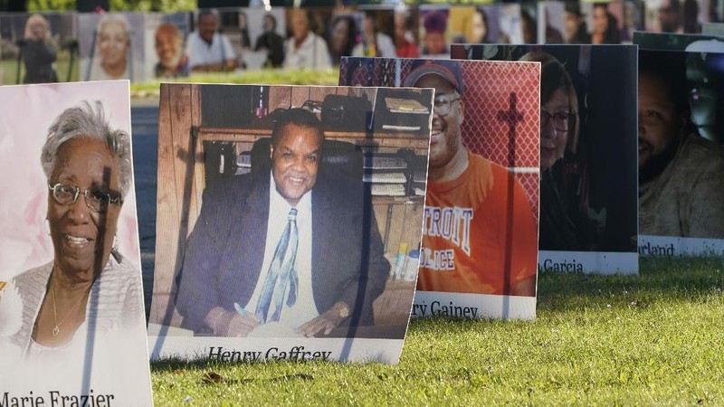 Some of the nearly 900 large poster-sized photos of Detroit victims of COVID-19 are displayed, Monday, Aug. 31, 2020 on Belle Isle in Detroit. Families have a chance to take one last public look at their lost loved ones in the nation's first citywide memorial to honor victims of the pandemic. Mourners will join 14 consecutive funeral processions to drive past the photos of their loved ones staked around the island. (AP Photo/Carlos Osorio)