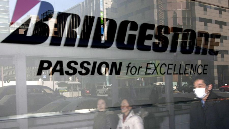 Bridgestone (AP/Shizuo Kambayashi) FILE - In this Thursday, Feb. 19, 2009, file photo, women walk past a Bridgestone sign in Tokyo. General Motors announced Thursday, April 20, 2017, that it will stop doing business in Venezuela after authorities took control of its only factory there. Bridgestone announced in May 2016 that it would sell its business in Venezuela after six decades in the country as a result of runaway inflation and strict currency controls. The company sold its Venezuela assets to Grupo Corimon, a local industrial company. (AP Photo/Shizuo Kambayashi, File)