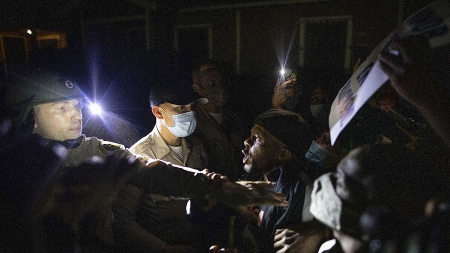 Protesters clash with deputies of the Los Angeles Sheriff's Department during protests following the death of Dijon Kizzee on Monday, Aug. 31, 2020, in Los Angeles, Calif. (AP Photo/Christian Monterrosa)