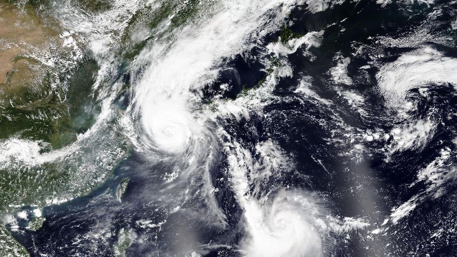 This Wednesday, Sept. 2, 2020, satellite image released by NASA Worldview, Earth Observing System Data and Information System (EOSDIS) shows Typhoon Maysak over South Korea, hidden behind the white circle at upper left, as another tropical storm, Haishen, lower center right, sweeps northward and is projected to slam Japan's southern main islands of Kyushu and Shikoku, as well as the southwestern tip of Honshu by this weekend. (NASA via AP)