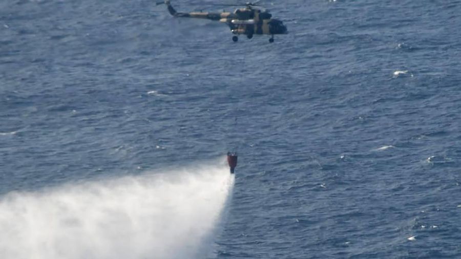 This photo released by Sri Lankan Air Force shows smoke rising after a fire broke out on a Panama-registered oil tanker about 38 nautical miles (70 kilometers) east of Sri Lanka, Thursday, Sept.3, 2020. (Sri Lankan Air Force via AP)