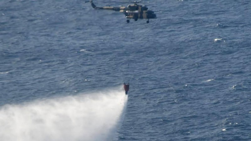 This photo released by Sri Lankan Air Force shows smoke rising after a fire broke out on a Panama-registered oil tanker about 38 nautical miles (70 kilometers) east of Sri Lanka, Thursday, Sept.3, 2020. (Sri Lankan Air Force via AP)