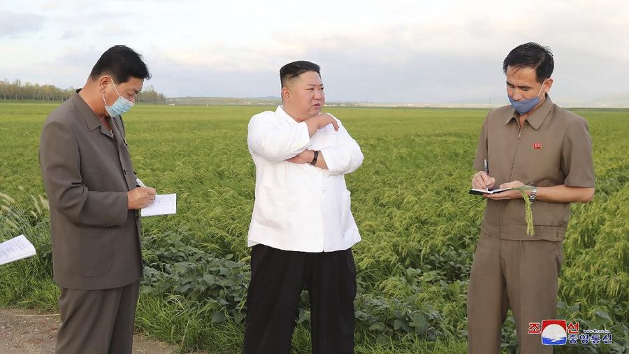 In this Saturday, Sept. 5, 2020, photo provided by the North Korean government, North Korea leader Kim Jong Un talks to officials as he visits a damaged area in the South Hamgyong province, North Korea, following a typhoon known as Maysak. Independent journalists were not given access to cover the event depicted in this image distributed by the North Korean government. The content of this image is as provided and cannot be independently verified. Korean language watermark on image as provided by source reads: 