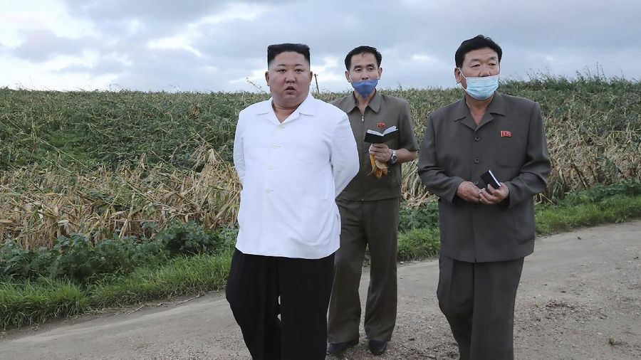 In this Saturday, Sept. 5, 2020, photo provided by the North Korean government, North Korea leader Kim Jong Un talks to officials as he visits a damaged area in the South Hamgyong province, North Korea, following a typhoon known as Maysak. Independent journalists were not given access to cover the event depicted in this image distributed by the North Korean government. The content of this image is as provided and cannot be independently verified. Korean language watermark on image as provided by source reads: 