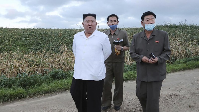 In this Saturday, Sept. 5, 2020, photo provided by the North Korean government, North Korea leader Kim Jong Un talks to officials as he visits a damaged area in the South Hamgyong province, North Korea, following a typhoon known as Maysak. Independent journalists were not given access to cover the event depicted in this image distributed by the North Korean government. The content of this image is as provided and cannot be independently verified. Korean language watermark on image as provided by source reads: 