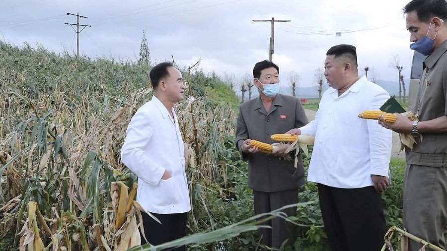 In this Saturday, Sept. 5, 2020, photo provided by the North Korean government, North Korea leader Kim Jong Un talks to officials as he visits a damaged area in the South Hamgyong province, North Korea, following a typhoon known as Maysak. Independent journalists were not given access to cover the event depicted in this image distributed by the North Korean government. The content of this image is as provided and cannot be independently verified. Korean language watermark on image as provided by source reads: 