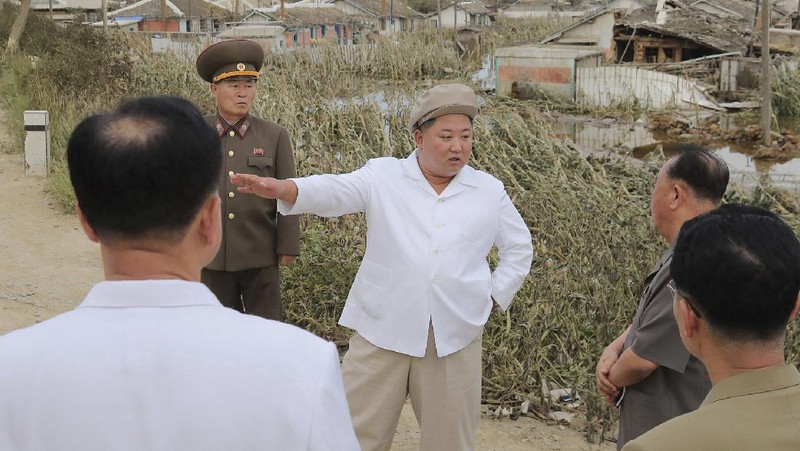 In this Saturday, Sept. 5, 2020, photo provided by the North Korean government, North Korea leader Kim Jong Un talks to officials as he visits a damaged area in the South Hamgyong province, North Korea, following a typhoon known as Maysak. Independent journalists were not given access to cover the event depicted in this image distributed by the North Korean government. The content of this image is as provided and cannot be independently verified. Korean language watermark on image as provided by source reads: 