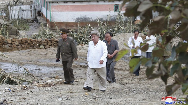 In this Saturday, Sept. 5, 2020, photo provided by the North Korean government, North Korea leader Kim Jong Un talks to officials as he visits a damaged area in the South Hamgyong province, North Korea, following a typhoon known as Maysak. Independent journalists were not given access to cover the event depicted in this image distributed by the North Korean government. The content of this image is as provided and cannot be independently verified. Korean language watermark on image as provided by source reads: 