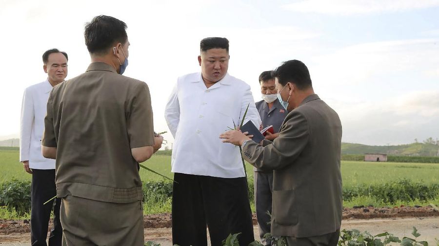 In this Saturday, Sept. 5, 2020, photo provided by the North Korean government, North Korea leader Kim Jong Un talks to officials as he visits a damaged area in the South Hamgyong province, North Korea, following a typhoon known as Maysak. Independent journalists were not given access to cover the event depicted in this image distributed by the North Korean government. The content of this image is as provided and cannot be independently verified. Korean language watermark on image as provided by source reads: 