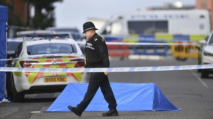A police forensics officer taking photographs in Irving Street, in Birmingham after a number of people were stabbed in the city centre, Sunday, Sept. 6, 2020. British police say that multiple people have been injured in a series of stabbings in a busy nightlife area of the central England city of Birmingham.(Jacob King/PA via AP)