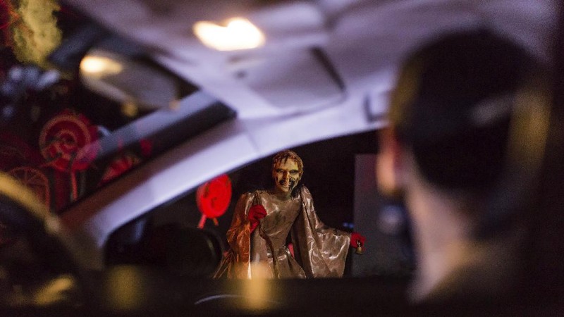 An actor dressed as a witch performs at the Hopi Hari horror theme amusement park, in the Vinhedo suburb of Sao Paulo, Brazil, Friday, Sept. 4, 2020. Due to the restrictions caused by COVID-19, the park created a drive-thru tour that allow the public to enjoy the experience by car. (AP Photo/Carla Carniel)